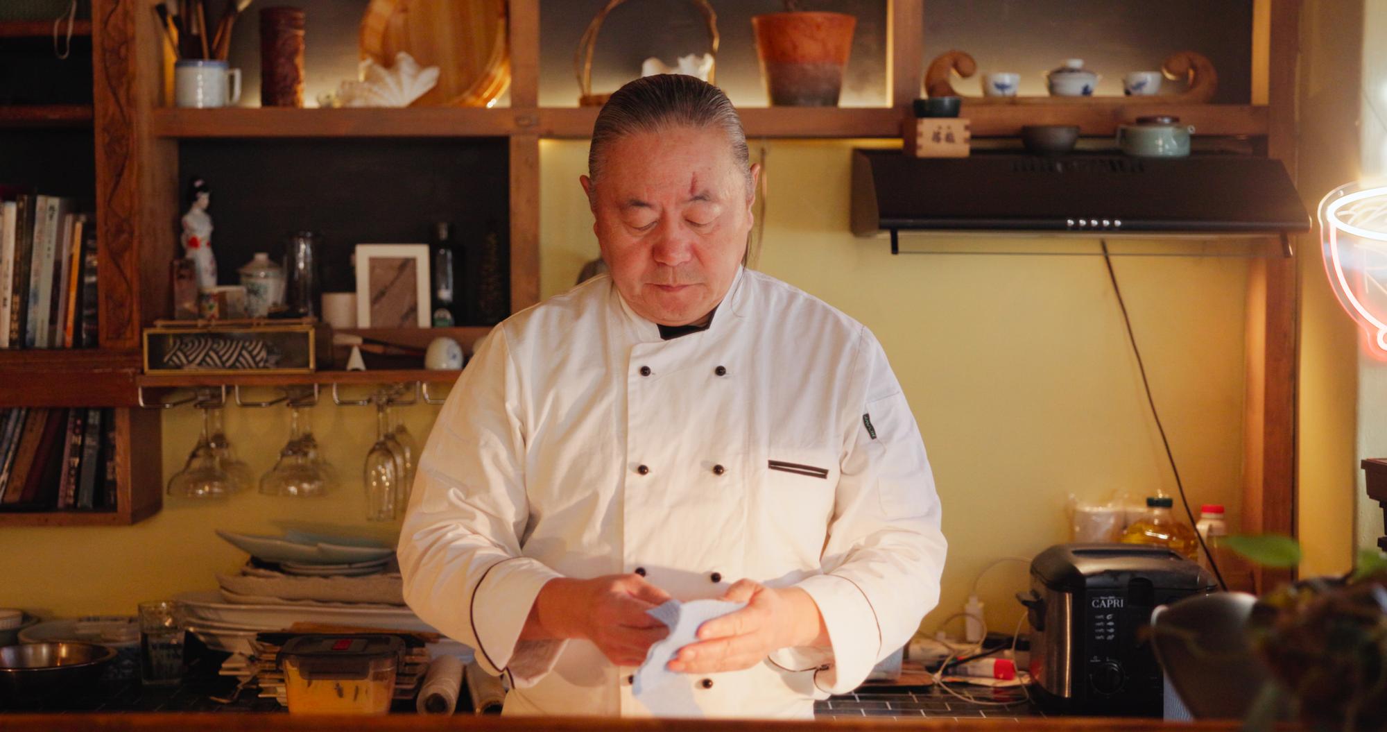 Portrait of head chef arranging food